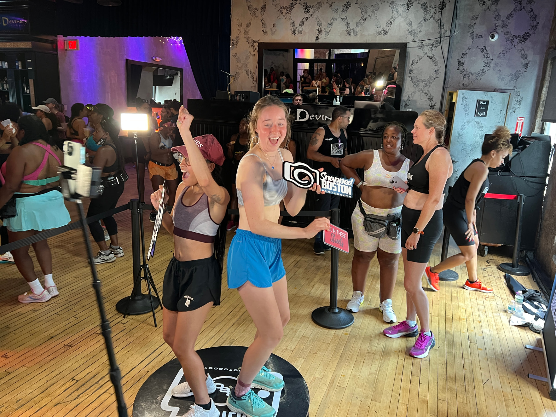 Guests celebrating on the Snapped Boston 360 booth at a fitness event