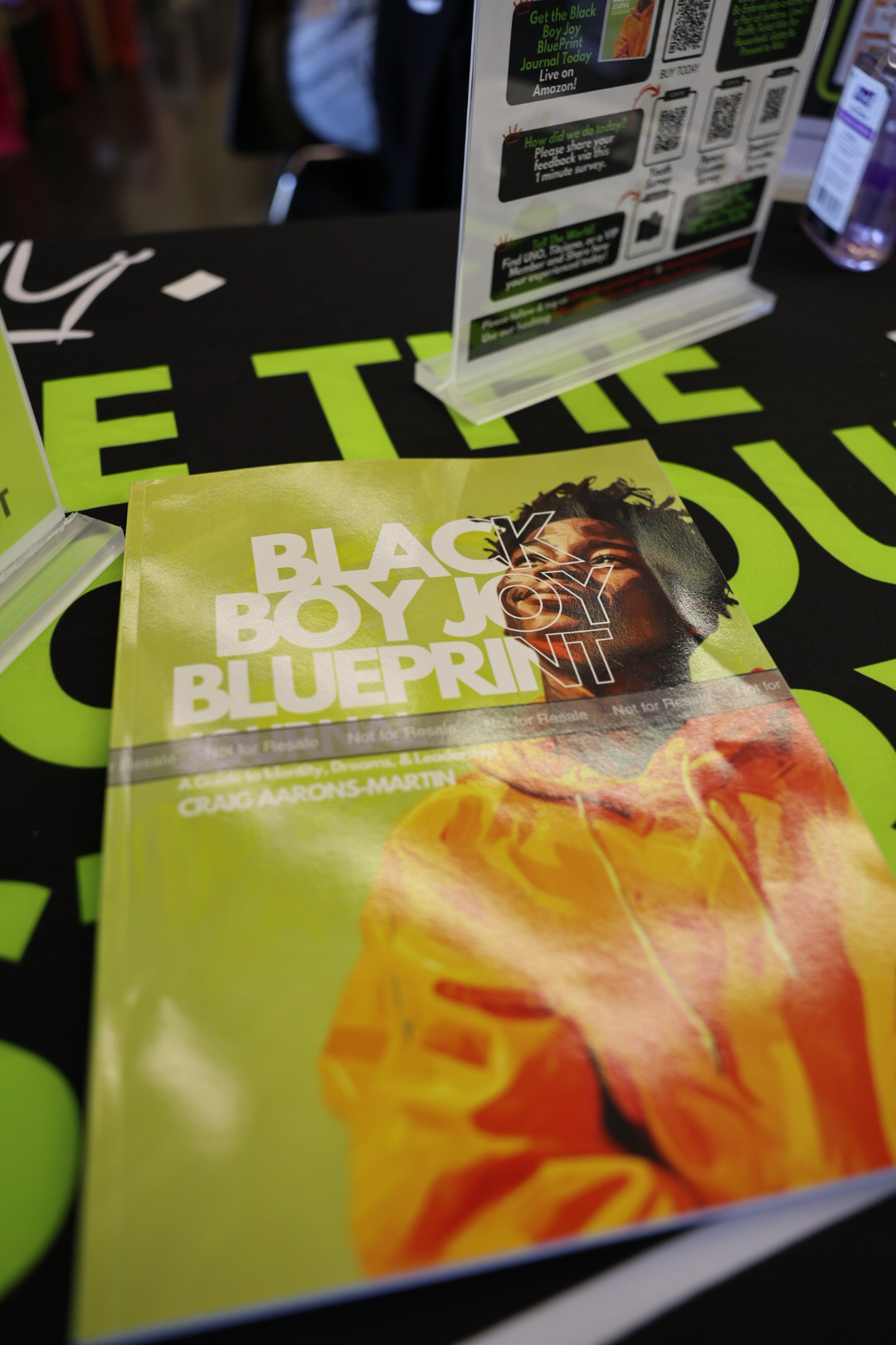 Black Boy Joy Blueprint book display at a community event
